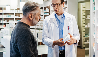 Pharmacist explaining medicine to patient